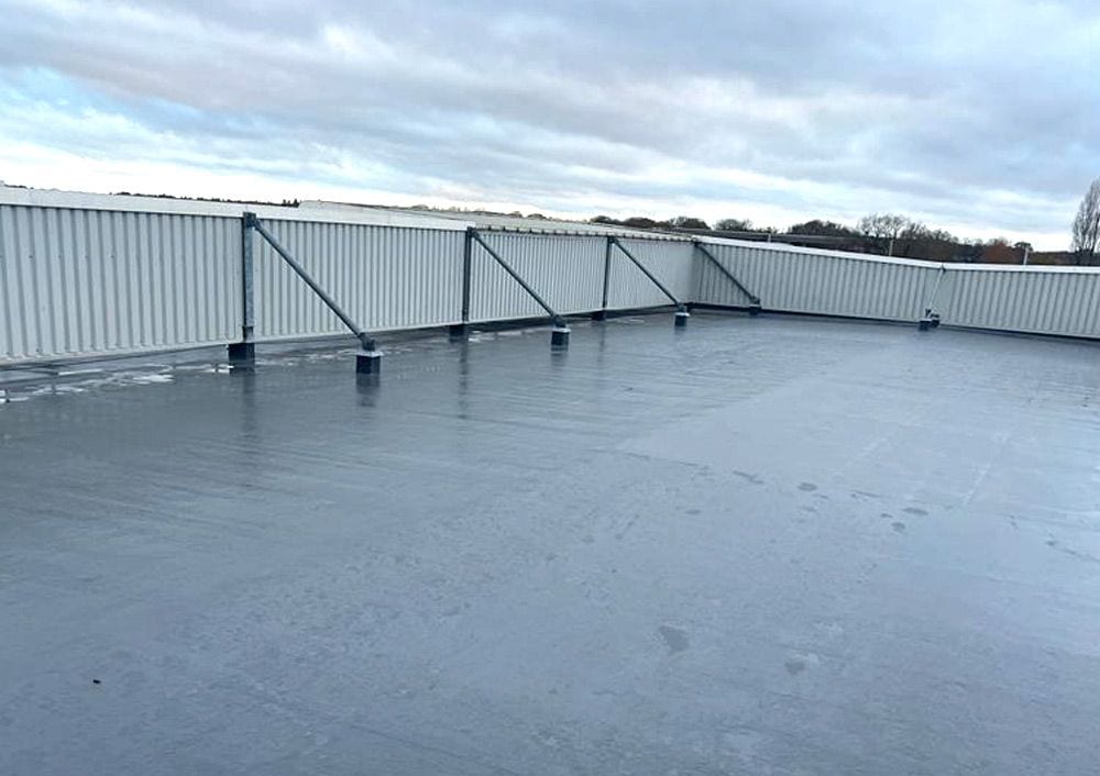 Completed single ply roof at One Central Boulevard, looking across the roof plane to the edge protection