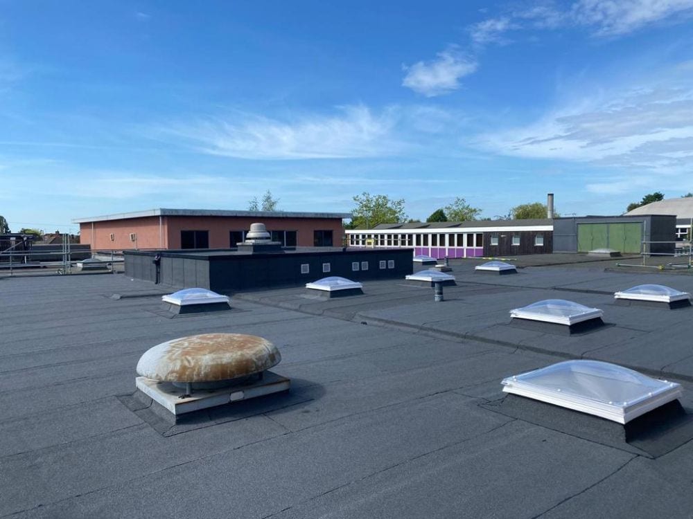 Completed flat roof at Thomas Wolsey School, with the school buildings occupied throughout