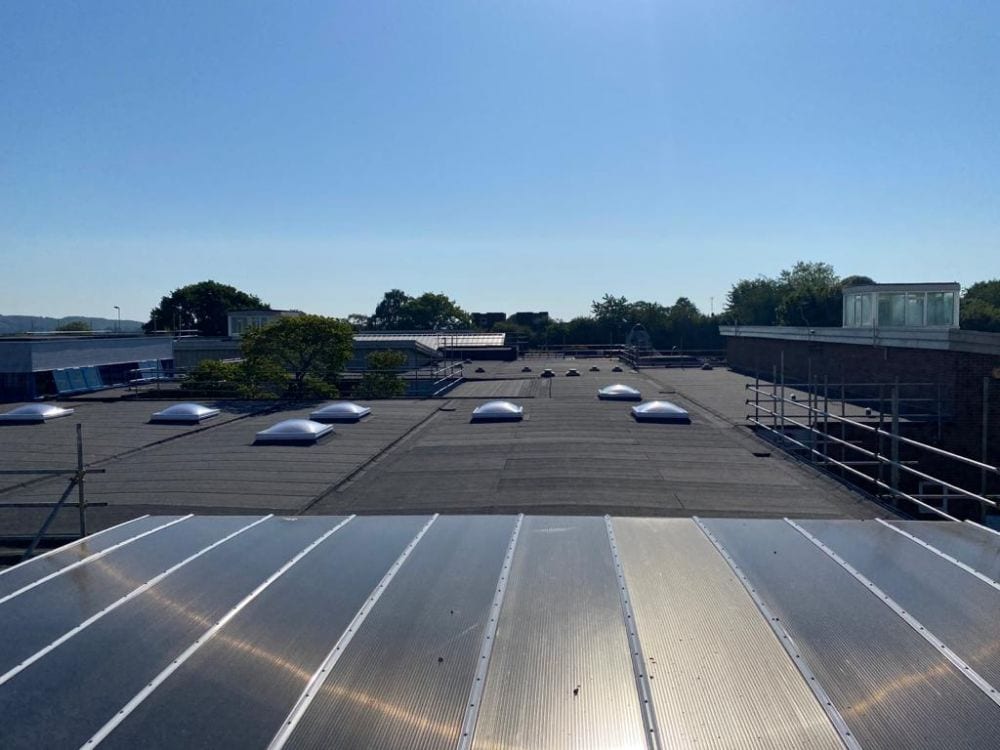 Completed roof covering and rooflights at Windmill Primary School in low afternoon sun