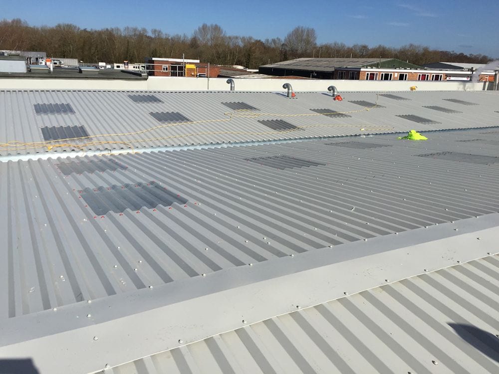 Absolute Waterproofing operatives working on a commercial roof